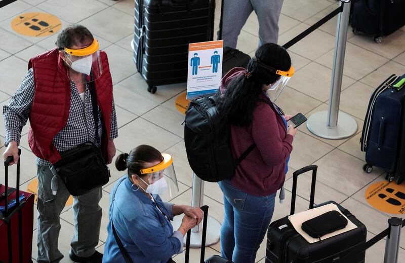 Passengers stand in line at the Tocumen International Airport amid the coronavirus outbreak, in Panama City, Panama. Reuters