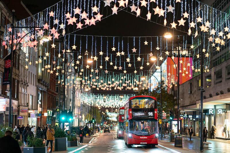 Christmas lights shine above on Oxford Street, in central London. Many shoppers are expected to buy online ahead of Christmas rather than visit the West End. AP