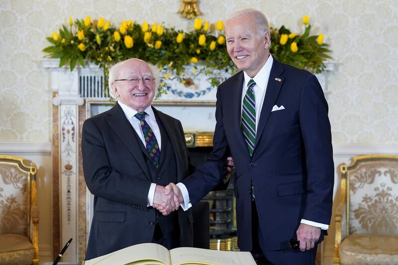 Mr Biden shakes hands with Mr Higgins in Dublin. Reuters