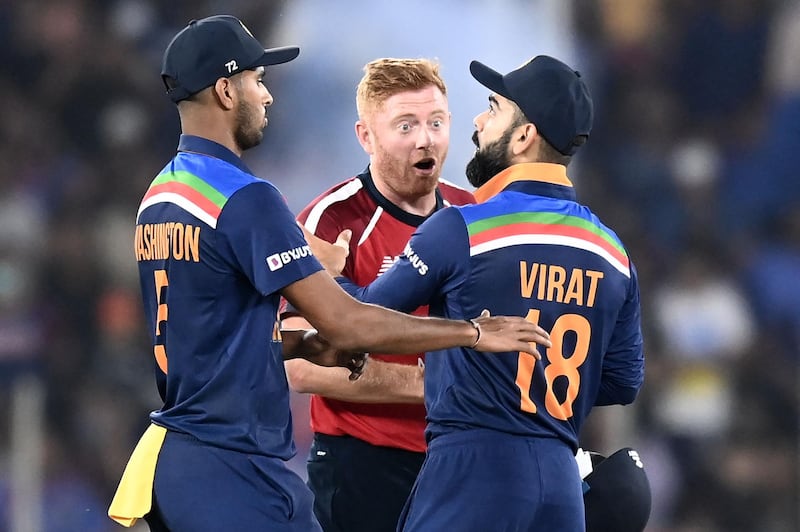England's Jonny Bairstow (C) speaks with India's captain Virat Kohli (R) as India's Washington Sundar watches
. AFP