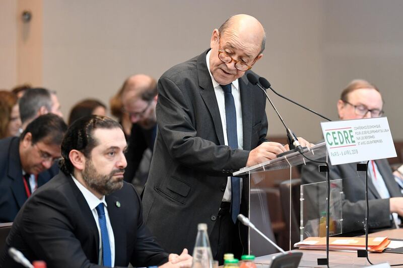 French Foreign Minister Jean-Yves Le Drian delivers his opening speech as Lebanese Prime Minister Saad Hariri (L) listens to during the Cedar (CEDRE) Conference for international donors and investors to support Lebanon's economy, in Paris, France, April 6, 2018.   Eric Feferberg/Pool via Reuters