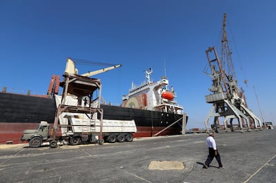 FILE PHOTO: A worker walks past a ship unloading grain at the Red Sea port of Hodeidah, Yemen, January 5, 2019. Picture taken January 5, 2019. REUTERS/Abduljabbar Zeyad/File Photo