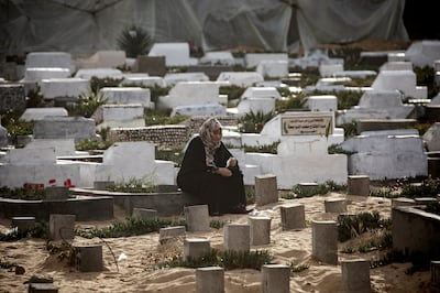 A displaced Palestinian visits a loved one grave on the first day of Eid, at the Rafah camp in the southern Gaza Strip, on 10 April 10. EPA 