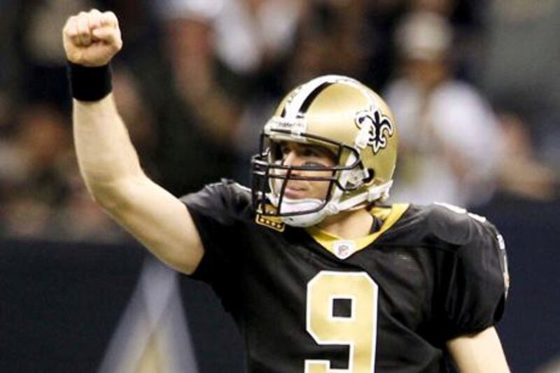 New Orleans Saints quarterback Drew Brees (9) celebrates after throwing a 42-yard touchdown pass to Marques Colsoton against the Carolina Panthers during their NFL football game at The Mercedes-Benz Superdome in New Orleans, Louisiana, in this January 1, 2012 file photo. The New Orleans Saints announced July 13, 2012 that they'd agreed to a five-year, $100 million contract with their record-setting quarterback Drew Brees agreed to.  REUTERS/Sean Gardner/Files     (UNITED STATES  - Tags: SPORT FOOTBALL)