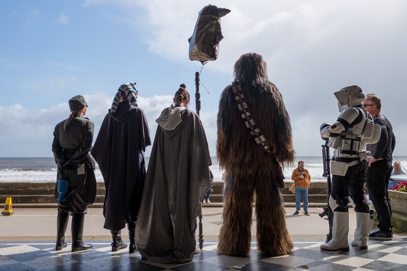 People dressed as characters from Star Wars including Ashoka, Rey, Chewbacca and a Stormtrooper