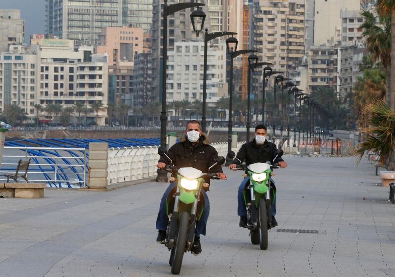 Police members wear face masks as they ride on motorbikes at Beirut's seaside Corniche as Lebanon declared a medical state of emergency. REUTERS