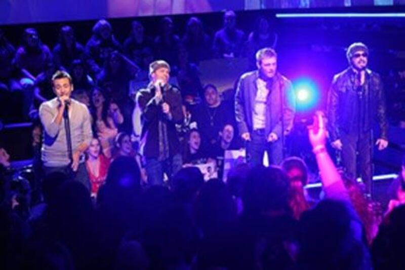 The Backstreet Boys - Howie Dorough, Brian Littrell, Nick Carter, and AJ McLean - performing for MTV in 2008.