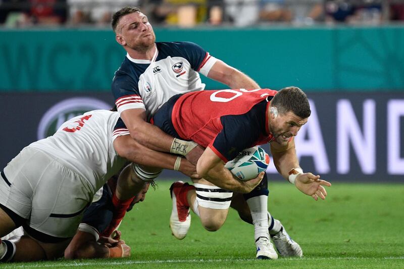 England back row Mark Wilson, right, is tackled by US flanker Tony Lamborn, left. AFP