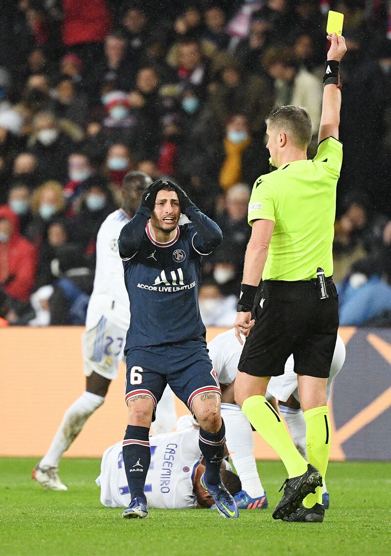 Italian referee Daniele Orsato shows a yellow card to PSG's Marco Verratti. AFP