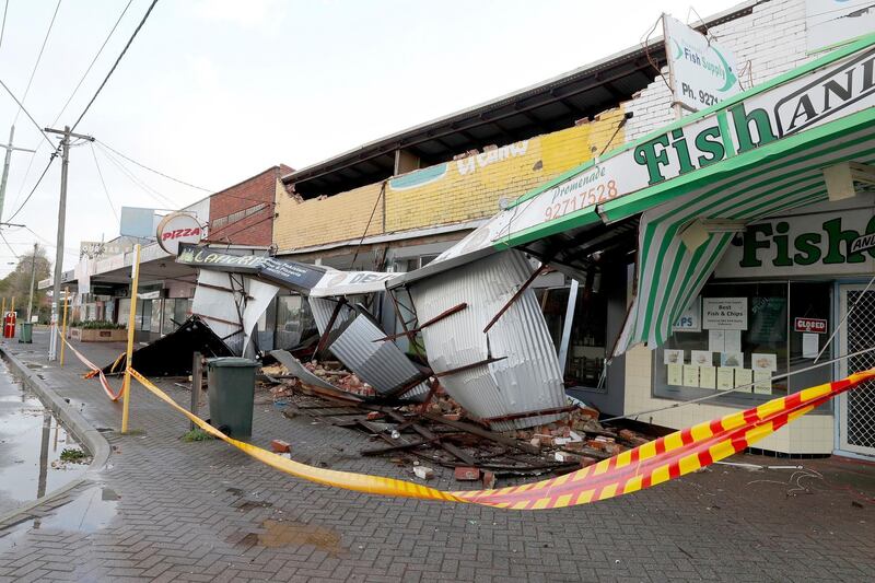 Debris falls from a row of damaged shops in Perth, Australia.  AP