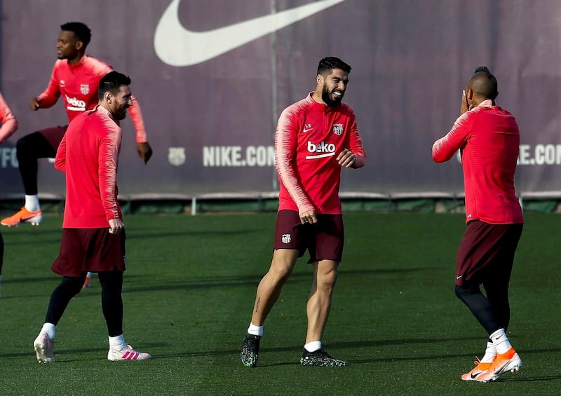 Lionel Messi, left, Luis Suarez, centre, and Arturo Vidal, right, attend a training session ahead of Barcelona's Uefa Champions League semi-final, first leg against Liverpool. EPA
