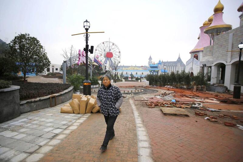 A local resident walks at a section of the Hello Kitty amusement park undergoing construction. Carlos Barria / Reuters