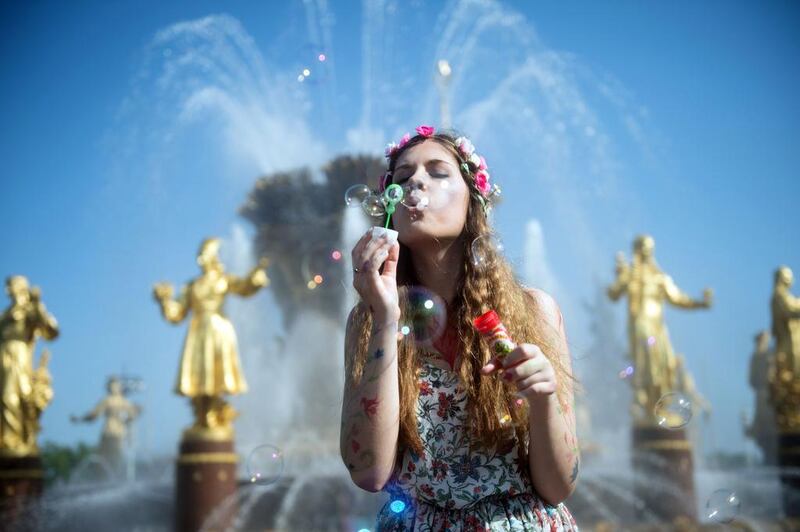A girl blows soap bubbles during a soap bubble festival Dreamflash in Mosco. Alexander Utkin / AFP