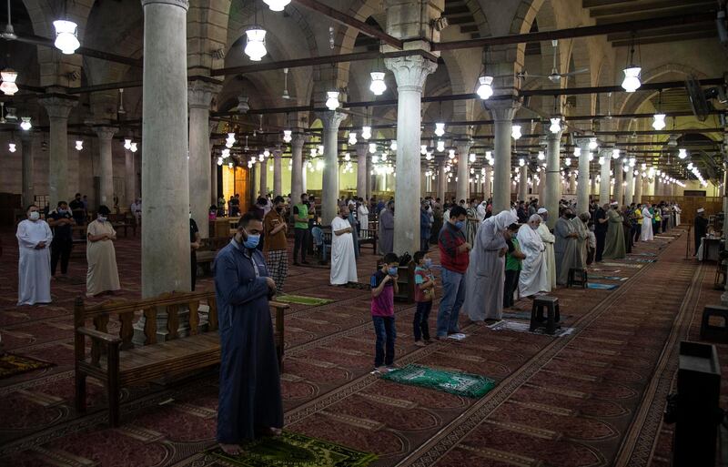 People take part in a dawn prayer inside Amr Ibn Al-As mosque in Cairo on June 27, 2020 as Egypt eased restrictions on public prayers, imposed to contain its coronavirus outbreak.  EPA