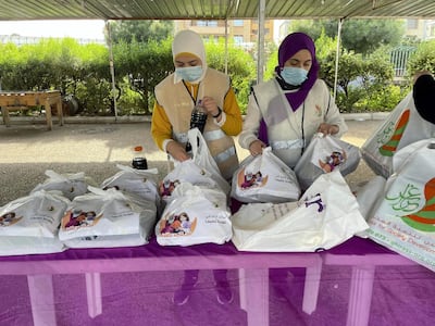 Volunteers at Ghiras NGO preparing iftar meals for pick up.
