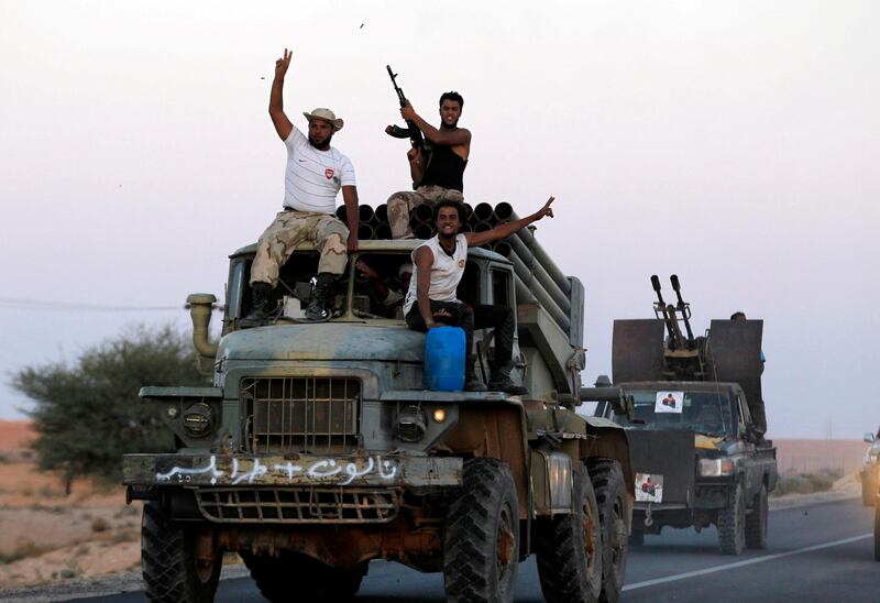 Anti-Gaddafi fighters cheer and shoot in the air as they drive a Grad multiple rocket launcher they said they had captured from pro-Gaddafi forces in the Libyan city of Bani Walid September 12, 2011.   REUTERS/Zohra Bensemra (LIBYA - Tags: CONFLICT MILITARY) *** Local Caption ***  ZOH22_LIBYA-_0912_11.JPG