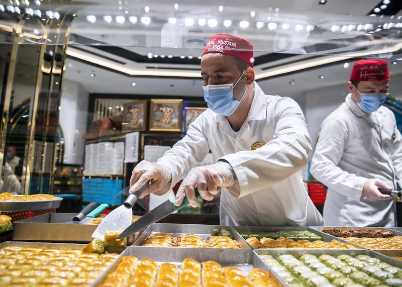 DUBAI, UNITED ARAB EMIRATES. 11 JUNE 2020. Staff of Hafiz Mustafa in facemasks at their shop in Dubai Mall.(Photo: Reem Mohammed/The National)Reporter:Section: