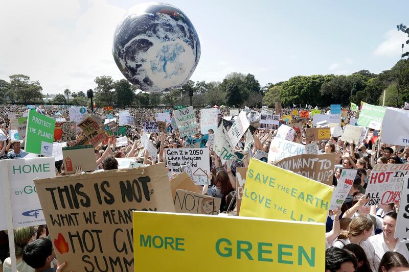 A large inflatable globe is bounced through the crowd as thousands of protestors, many of them school students, gather in Sydney, Friday, Sept. 20, 2019, calling for action to guard against climate change. Australia's acting Prime Minister Michael McCormack has described ongoing climate rallies as "just a disruption" that should have been held on a weekend to avoid inconveniencing communities. (AP Photo/Rick Rycroft)