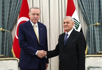 Turkish President Recep Tayyip Erdogan, left, shake hands with Iraqi President Abdul Latif Rashid. AP