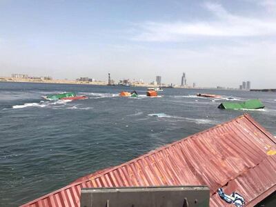Containers lie in the water in Karachi port after a collision on March 19