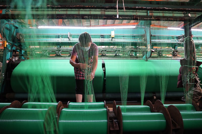 A worker produces fibre netting at a factory in Binzhou in China's eastern Shandong province. AFP