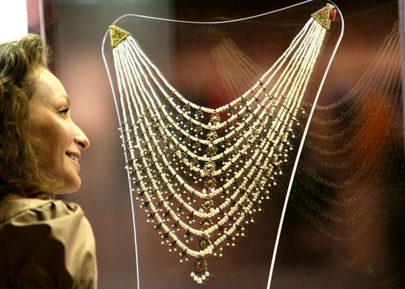 Isabelle de La Bruyere, the Middle East director for Christie's auction house, admires an antique Indian pearl necklace.