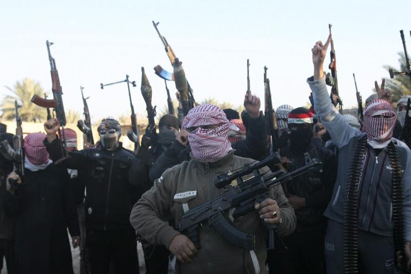 Masked Sunni gunmen chant slogans during a protest against Iraq's government in Fallujah on January 7. Reuters