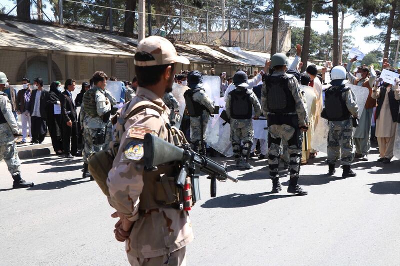 epa08414986 Afghans shout slogans outside the Iranian consulate during a protest against the Iranian regime and demand justice for the Afghans allegedly killed by the Iranian security forces, in Herat, Afghanistan, on May 11, 2020. EPA