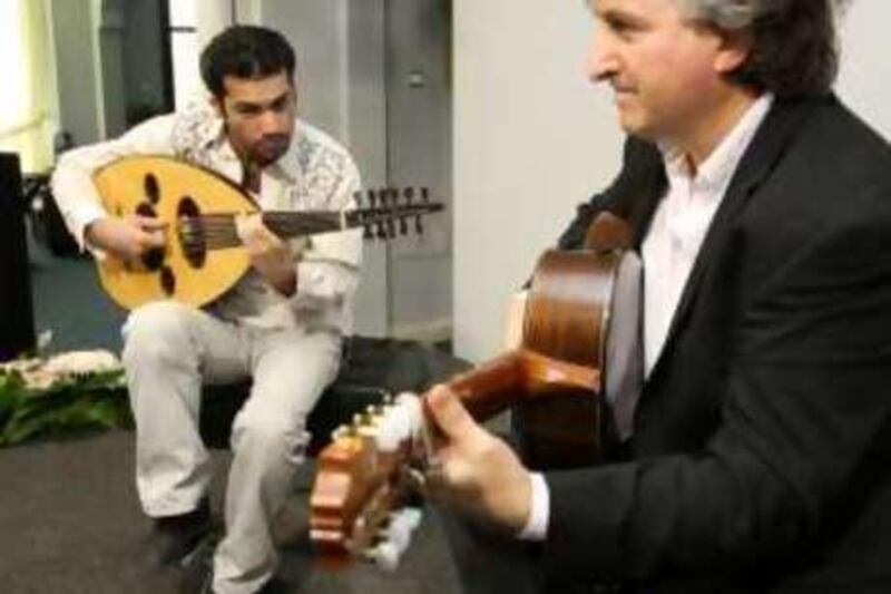 Abu Dhabi, UAE - April 21, 2008 -  Ahmed Shamma (left) plays the Oud, with Eduardo Nuebla. A workshop is led by virtuoso guitarist, Eduardo Nuebla, as part of a campaign to revive traditional Arabic instruments like the oud and ghanoon.  The workshop is held at the Beit al Oud. (Nicole Hill / The National)
 *** Local Caption *** NH OUD WORKSHOP230.JPG