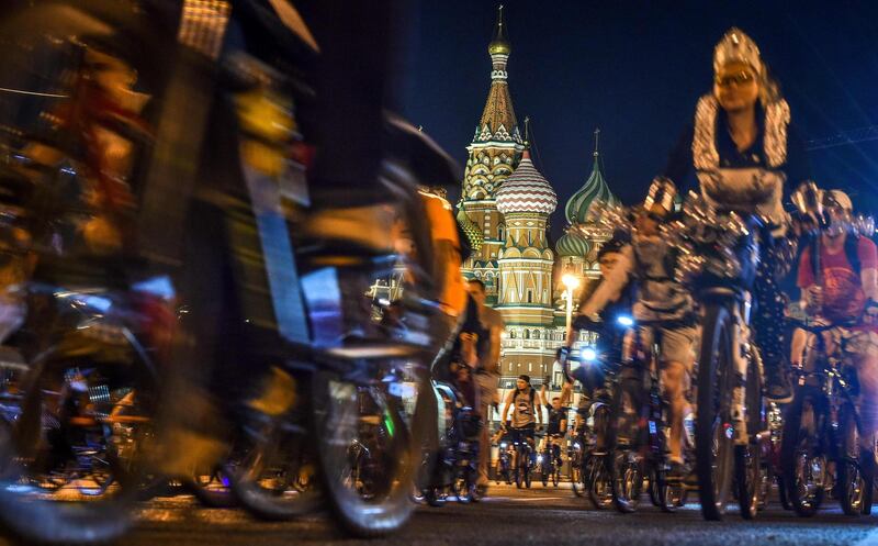 Cyclists ride in front of St. Basil Cathedral in central Moscow. Vasily Maximov/AFP