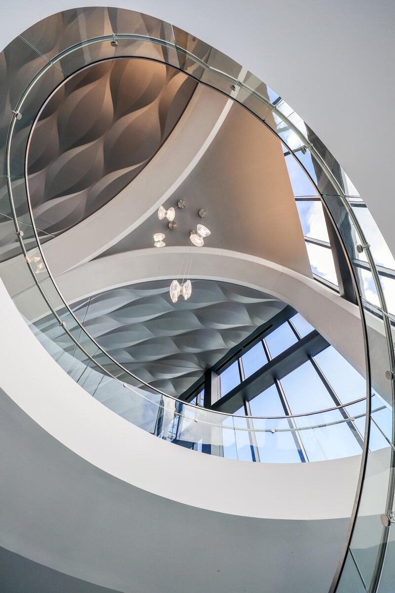 Curvilinear details include flowing lines and curved staircases. 