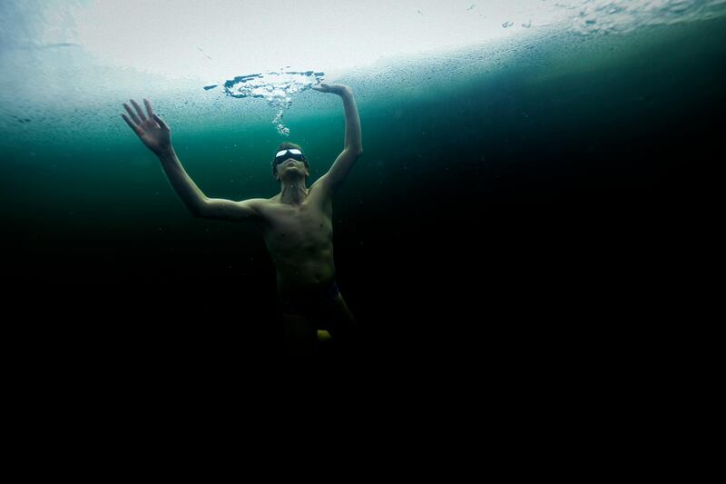 Finland's freediver Kristian Maki-Jussila, 37, swims under the ice in a frozen lake on March 28, 2020. - On March 21, 2020, Kristian Maki-Jussila did the unofficial world record of swimming distance freediving in bathing suit of 101m, in a  frozen lake in Northern Finland. (Photo by Olivier MORIN / AFP)