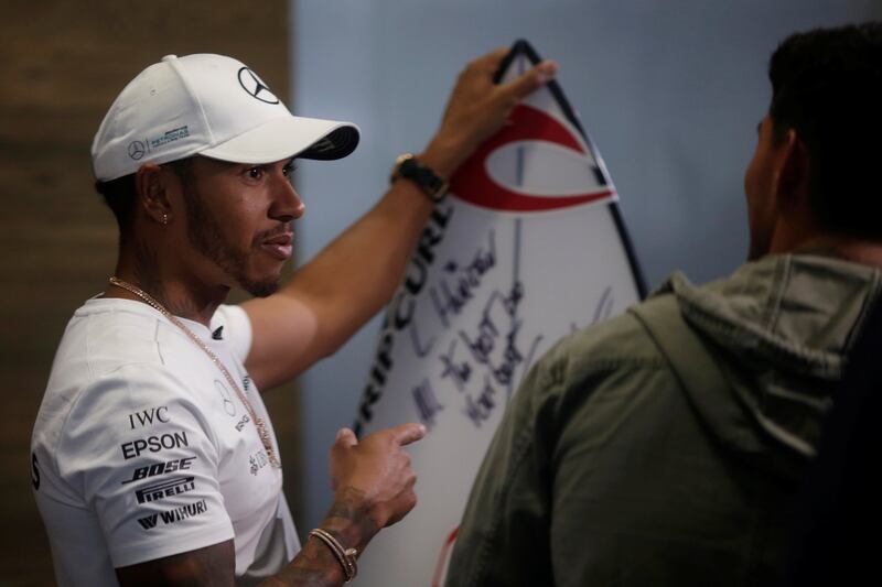 Mercedes Formula One driver Lewis Hamilton of Britain talks with Brazilian surfer Gabriel Medina at Interlagos circuit in Sao Paulo, Brazil November 9, 2017. REUTERS/Ueslei Marcelino
