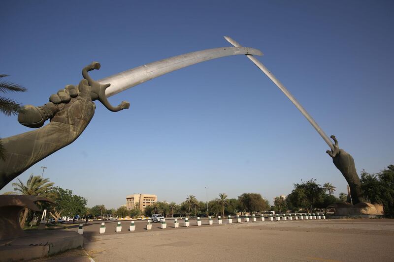 A picture taken on June 3, 2019 shows the Victory Arch known as the Swords of Qadisiyah in Baghdad's high-security Green Zone. The Green Zone, home to the Iraqi parliament and US embassy, will be opened to traffic around the clock from Tuesday, the government said. It has been heavily fortified since the US-led invasion that overthrew dictator Saddam Hussein in 2003, with nearly all Iraqis denied access to its 10 square kilometres. / AFP / AHMAD AL-RUBAYE
