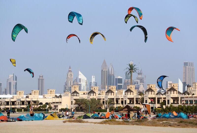 Dubai, United Arab Emirates - December 11, 2018: Dozens of kite suffers head to the beach to enjoy the wide conditions. Tuesday the 11th of December 2018 at Jumeirah Beach, Dubai. Chris Whiteoak / The National