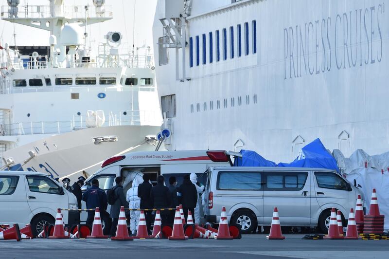 Personnel clad in protective gear and tasked to provide care for suspected coronavirus patients on board the Diamond Princess cruise ship prepare to leave as over 3,700 people remain quarantined onboard. AFP