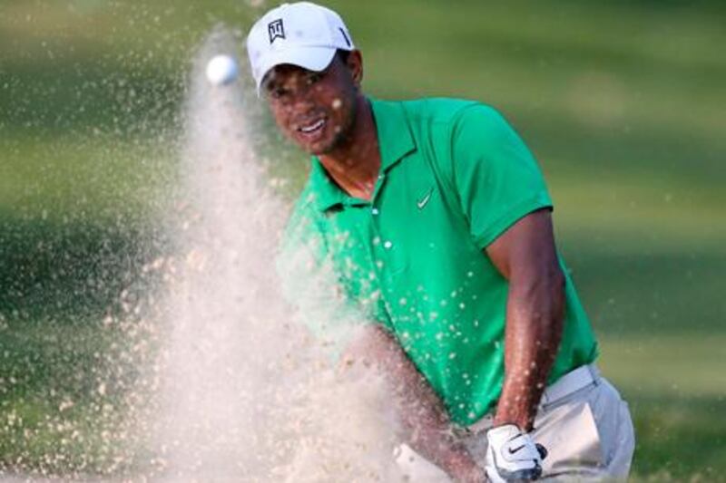 Tiger Woods hits out of a bunker onto the 14th green during the third round of the AT&T National golf tournament at Congressional Country Club in Bethesda, Md., Saturday, June 30, 2012. (AP Photo/Patrick Semansky)