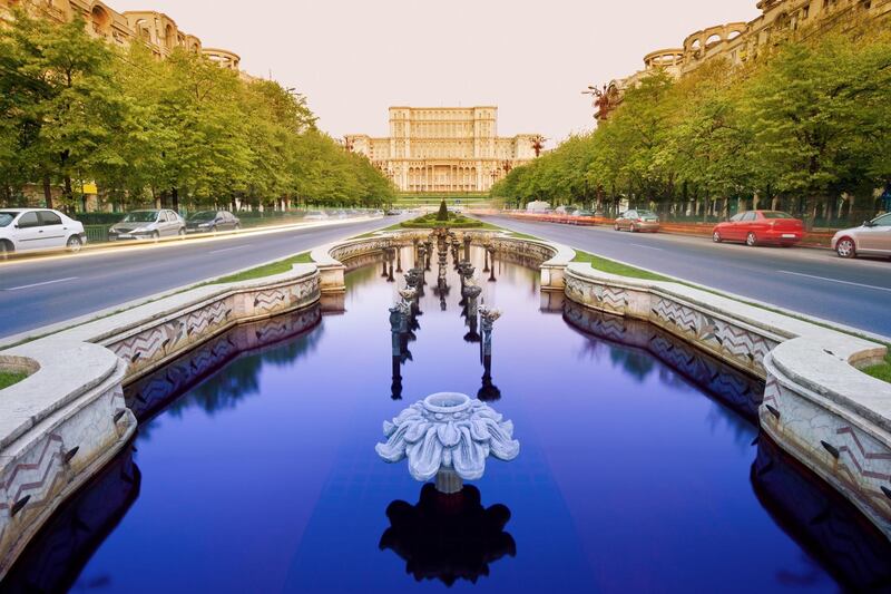 Fountains along the tree-lined Bulevardul Unirii, a major thoroughfare in central Bucharest, with the Palace of the Parliament in the background. Getty Images