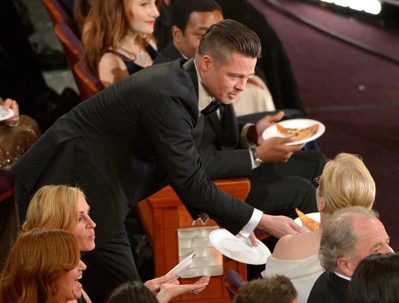 Brad Pitt, left, shares pizza with Meryl Streep. John Shearer / Invision / AP