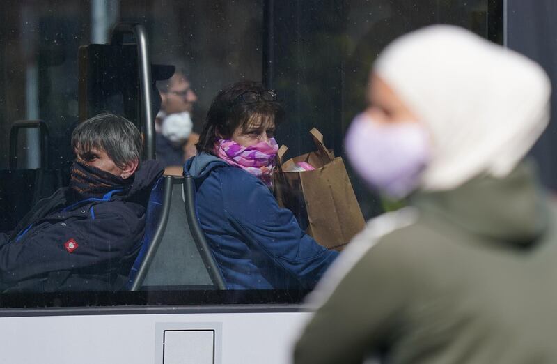 LEIPZIG, GERMANY - APRIL 20: People wearing protective face masks ride a street tram on the first day face masks became compulsory on public transport in the state of Saxony during the novel coronavirus crisis on April 20, 2020 in Leipzig, Germany. Germany is taking its first steps to ease restrictions on public life that had been imposed weeks ago in order to stem the spread of the coronavirus. Shops across the country are reopening, factory assembly lines are restarting and high schools are holding final exams. Health leaders are monitoring the process carefully for any resurgence of coronavirus infections. The number of infections nationwide is still rising, though so far at a declining rate. (Photo by Sean Gallup/Getty Images)