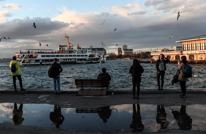 People enjoy their time near Kadikoy ferry station  on a windy day in Istanbul, Turkey.  EPA