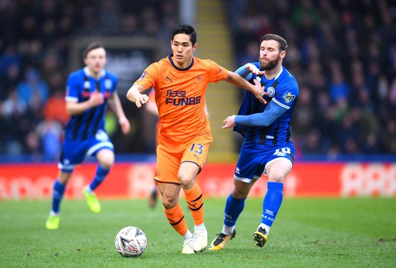 ROCHDALE, ENGLAND - JANUARY 04: Yoshinori Muto of Newcastle United runs with the ball under pressure from Jimmy Ryan of Rochdale during the FA Cup Third Round match between Rochdale AFC and Newcastle United at Spotland Stadium on January 04, 2020 in Rochdale, England. (Photo by Laurence Griffiths/Getty Images)