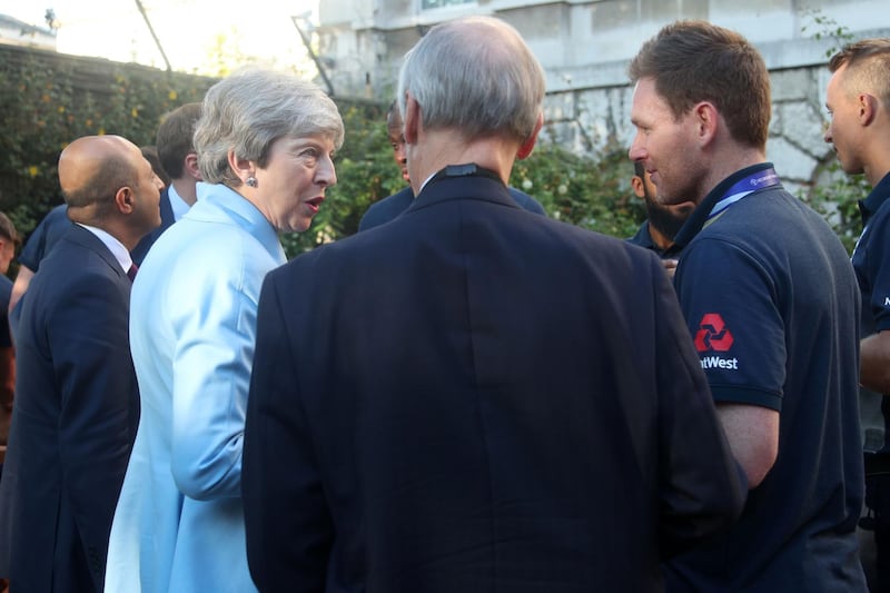 British prime minister Theresa May chats with England captain Eoin Morgan in the garden of 10 Downing Street. AFP