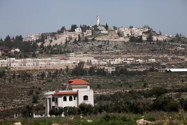 A Palestinian villa in the West Bank village of Turmus'ayya, with  the Israeli settlement of Shilo in the background. Anne Paq / The National