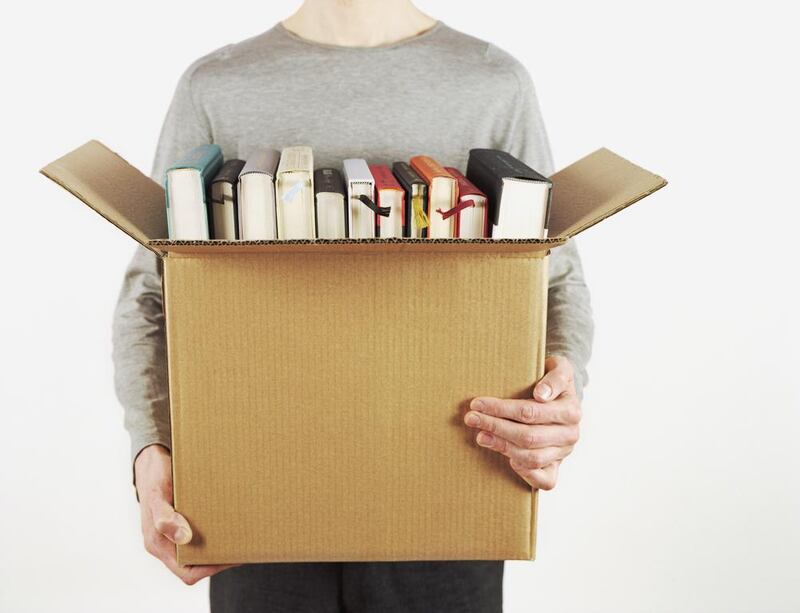 Man Holding Box of Books