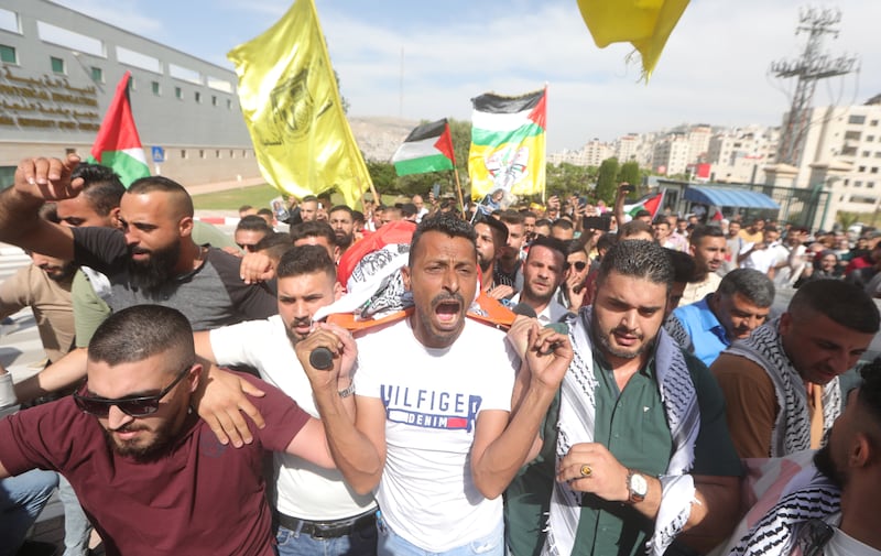 Palestinians carry Abu Akleh's body at her funeral in the West Bank city of Nablus. EPA