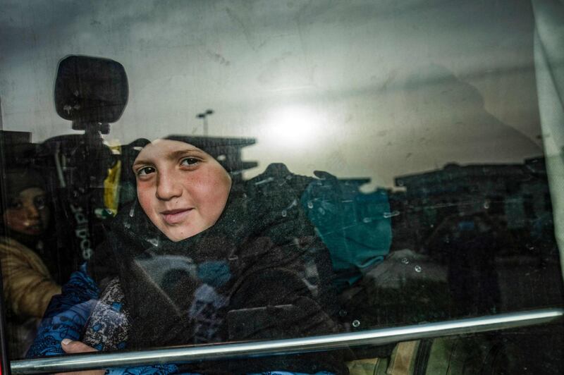 A child sits in a bus during the handover of orphaned children whose parents were suspected of belonging to ISIS to a Russian delegation by Syrian Kurdish officials in Qamishli, north-east Syria. The children, aged between three and 14, were taken into the care of the delegation headed by Anna Kouznetsova, the Russian president's envoy for children's rights. AFP