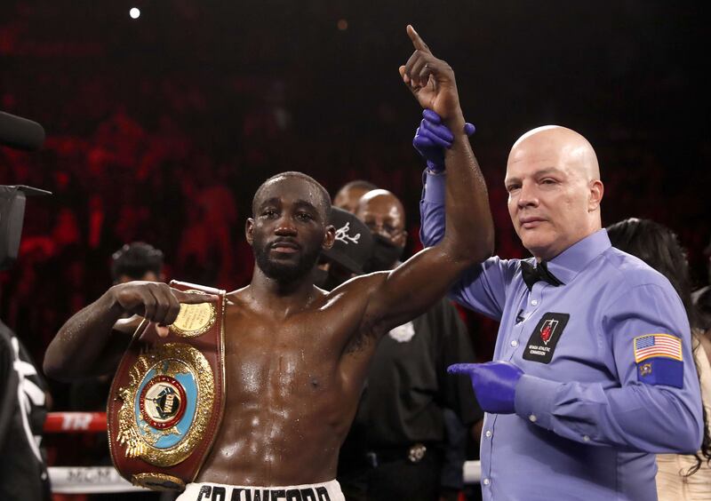 WBO champion Terence Crawford poses with referee Celestino Ruiz after defeating Shawn Porter. AFP