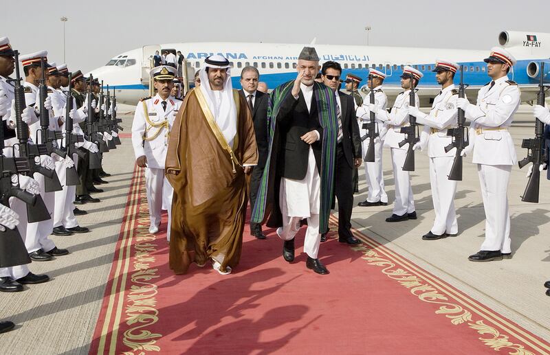 Hamid Karzai is greeted by the UAE Minsiter of Justice Hadef bin Juaan Al Dhaheri on his arrival at Abu Dhabi airport. Philip Cheung / The National