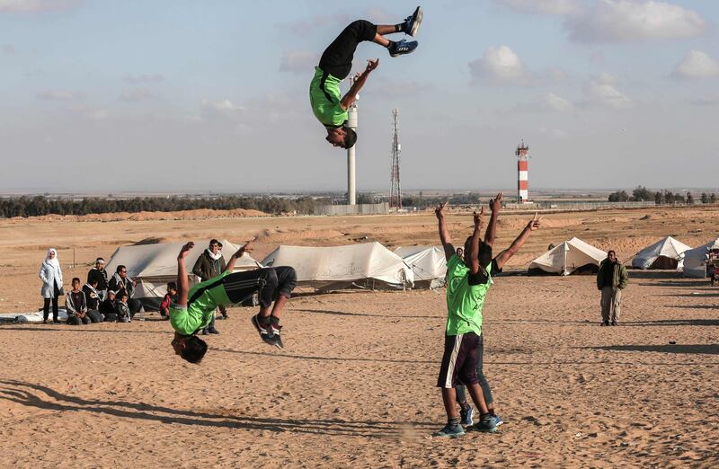 Palestinian youths practice their parkour skills at the Israel-Gaza border in the southern Gaza Strip. Said Khatib / AFP